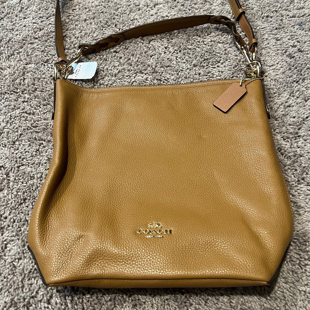 NWT Coach handbag with shoulder and crossbody straps.